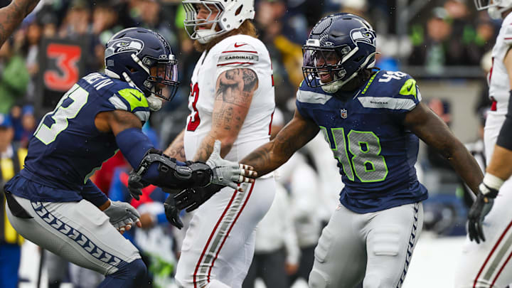 Nov 24, 2024; Seattle, Washington, USA; Seattle Seahawks linebacker Tyrice Knight (48) celebrates with linebacker Ernest Jones IV (13) following a sack against the Arizona Cardinals during the first quarter at Lumen Field.