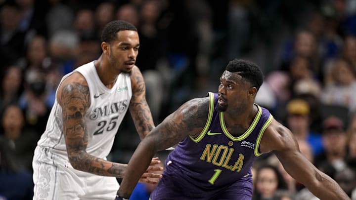 Feb 21, 2025; Dallas, Texas, USA; New Orleans Pelicans forward Zion Williamson (1) looks to move the ball past Dallas Mavericks forward P.J. Washington (25) during the second half at the American Airlines Center. Mandatory Credit: Jerome Miron-Imagn Images
