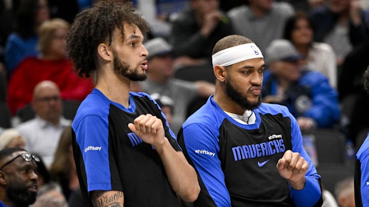 Dec 23, 2024; Dallas, Texas, USA; Dallas Mavericks center Dereck Lively II (left) and center Daniel Gafford (center) and guard Quentin Grimes (right) celebrate on the team bench during the second half against the Portland Trail Blazers at the American Airlines Center. Mandatory Credit: Jerome Miron-Imagn Images