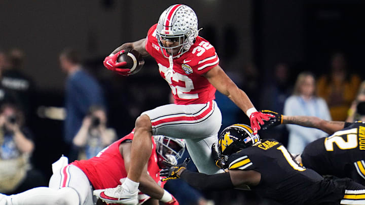 Dec 29, 2023; Arlington, Texas, USA; Ohio State Buckeyes running back TreVeyon Henderson (32) carries the ball against Missouri Tigers defensive back Jaylon Carlies (1) in the first quarter during the Goodyear Cotton Bowl Classic at AT&T Stadium.