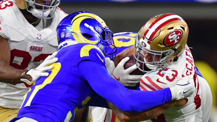 Oct 2, 2025; Inglewood, California, USA; Los Angeles Rams safety Quentin Lake (37) makes a tackle on San Francisco 49ers running back Christian McCaffrey (23) during the second half at SoFi Stadium. Mandatory Credit: Gary A. Vasquez-Imagn Images
