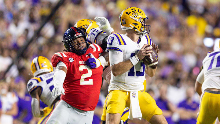 Oct 12, 2024; Baton Rouge, Louisiana, USA;  Mississippi Rebels defensive tackle Walter Nolen (2) reaches to knock the ball loose from LSU Tigers quarterback Garrett Nussmeier (13) during the first half at Tiger Stadium. Mandatory Credit: Stephen Lew-Imagn Images