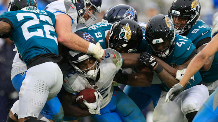 Tennessee Titans running back Tyjae Spears (2) rushes for yards against Jacksonville Jaguars defensive end Arik Armstead (91) and defensive end Josh Hines-Allen (41) during the second quarter of an NFL football matchup Sunday, Dec. 29, 2024 at EverBank Stadium in Jacksonville, Fla. [Corey Perrine/Florida Times-Union]
