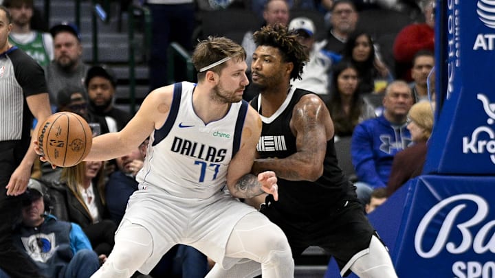 Jan 9, 2024; Dallas, Texas, USA; Dallas Mavericks guard Luka Doncic (77) looks to move to the basket past Memphis Grizzlies guard Marcus Smart (36) during the second half at the American Airlines Center. Mandatory Credit: Jerome Miron-Imagn Images