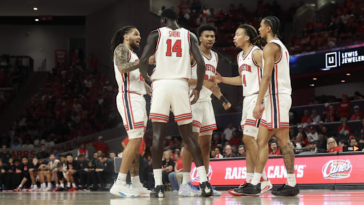 Feb 28, 2026; Houston, Texas, USA;  Houston Cougars guard Emanuel Sharp (21) and teammates talk with each other after a Colorado Buffaloes timeout in the first half at Fertitta Center. Mandatory Credit: Thomas Shea-Imagn Images