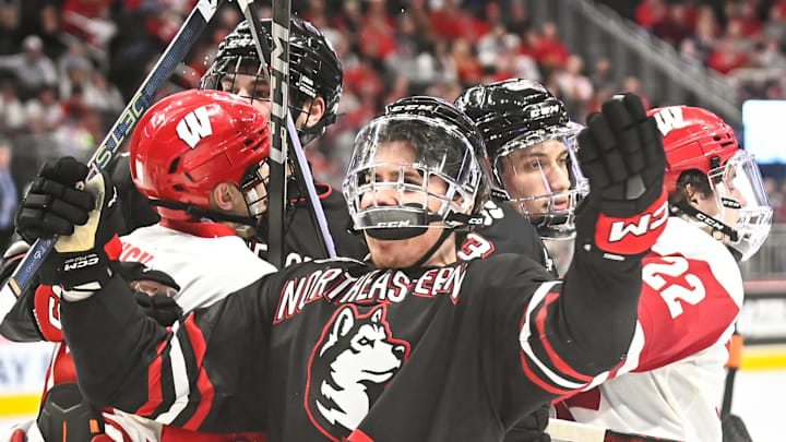 Wisconsin forward Jack Horbach (22) pulls Northeastern forward Matt Choupani (9) away from a scrap in front of the Wisconsin goal during the third period of the championship game of the Kwik Trip Holiday Face-Off on Friday, December 29, 2023, at Fiserv Forum in Milwaukee, Wisconsin. Wisconsin forward Jack Horbach (22) pulls Northeastern forward Matt Choupani (9) away from a scrap in front of the Wisconsin goal during the third period of the championship game of the Kwik Trip Holiday Face-Off on Friday, December 29, 2023, at Fiserv Forum in Milwaukee, Wisconsin.