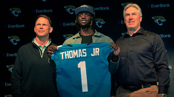 Jacksonville Jaguars wide receiver Brian Thomas Jr. (1), center, holds up his new jersey next to general manager Trent Baalke, left, and head coach Doug Pederson during a press conference Friday, April 26, 2024 at EverBank Stadium’s Miller Electric Center in Jacksonville, Fla. Jacksonville Jaguars selected LSU’s wide receiver Thomas Jr. as the 23rd overall pick in last night’s NFL Draft. [Corey Perrine/Florida Times-Union]