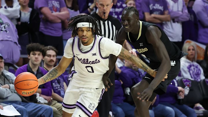 Mar 2, 2025; Manhattan, Kansas, USA; Kansas State Wildcats guard Dug McDaniel (0) dribbles around Colorado Buffaloes forward Bangot Dak (8) during the second half at Bramlage Coliseum. Mandatory Credit: Scott Sewell-Imagn Images Mar 2, 2025; Manhattan, Kansas, USA; Kansas State Wildcats guard Dug McDaniel (0) dribbles around Colorado Buffaloes forward Bangot Dak (8) during the second half at Bramlage Coliseum. Mandatory Credit: Scott Sewell-Imagn Images