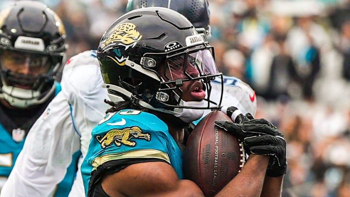 Jacksonville Jaguars running back Bhayshul Tuten (33) runs across the goal line to score a touchdown during the fourth quarter in an NFL football matchup at EverBank Stadium, Sunday, Jan. 4, 2026, in Jacksonville, Fla. The Jaguars defeated the Titans 41-7.