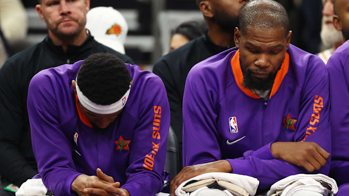 Dec 19, 2024; Phoenix, Arizona, USA; Phoenix Suns guard Bradley Beal (left) and forward Kevin Durant react on the bench against the Indiana Pacers at Footprint Center. Mandatory Credit: Mark J. Rebilas-Imagn Images