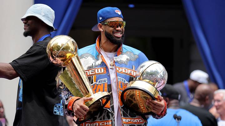 Jun 18, 2026; New York, NY, USA; New York Knicks center Karl-Anthony Towns celebrates with the Larry O'Brien championship trophy and the eastern conference finals trophy during a ceremony at New York City Hall after the championship parade. 