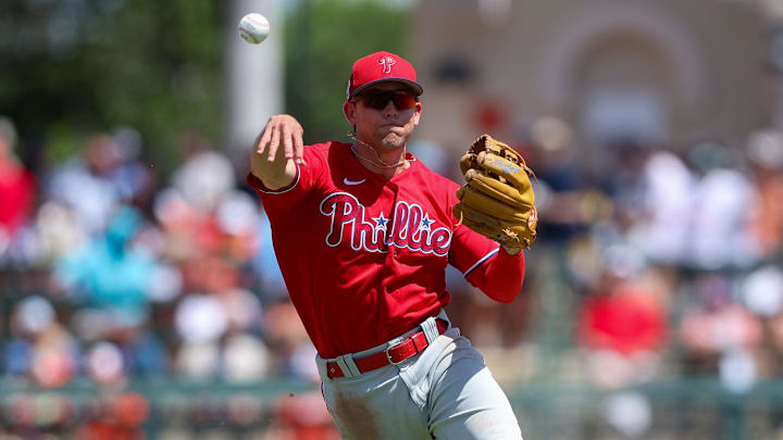 Mar 26, 2023; Sarasota, Florida, USA; Philadelphia Phillies shortstop Scott Kingery (4) throws to first against the Baltimore Orioles in the fourth inning during spring training at Ed Smith Stadium. Mar 26, 2023; Sarasota, Florida, USA; Philadelphia Phillies shortstop Scott Kingery (4) throws to first against the Baltimore Orioles in the fourth inning during spring training at Ed Smith Stadium.