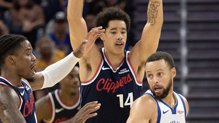 Oct 17, 2025; San Francisco, California, USA; Los Angeles Clippers forward Jahmyl Telfort (19) and center Yanic Konan Niederhäuser (14) double team Golden State Warriors guard Stephen Curry (30) during the fourth quarter at Chase Center. Mandatory Credit: D. Ross Cameron-Imagn Images