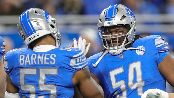 Detroit Lions defensive tackle Alim McNeill, right, high-fives linebacker Derrick Barnes during warmups 