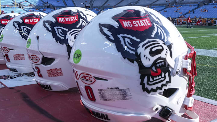 Sep 7, 2024; Charlotte, North Carolina, USA; North Carolina State Wolfpack helmets during pregame activity for the Dukes Mayo Classic against the Tennessee Volunteers at Bank of America Stadium. Mandatory Credit: Jim Dedmon-Imagn Images Sep 7, 2024; Charlotte, North Carolina, USA; North Carolina State Wolfpack helmets during pregame activity for the Dukes Mayo Classic against the Tennessee Volunteers at Bank of America Stadium. Mandatory Credit: Jim Dedmon-Imagn Images