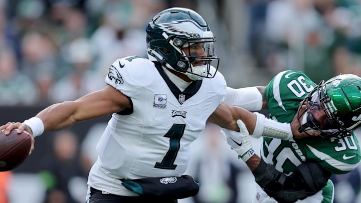 Oct 15, 2023; East Rutherford, New Jersey, USA; Philadelphia Eagles quarterback Jalen Hurts (1) looks to pass while pressured by New York Jets cornerback Michael Carter II (30) during the first quarter at MetLife Stadium. Mandatory Credit: Brad Penner-Imagn Images