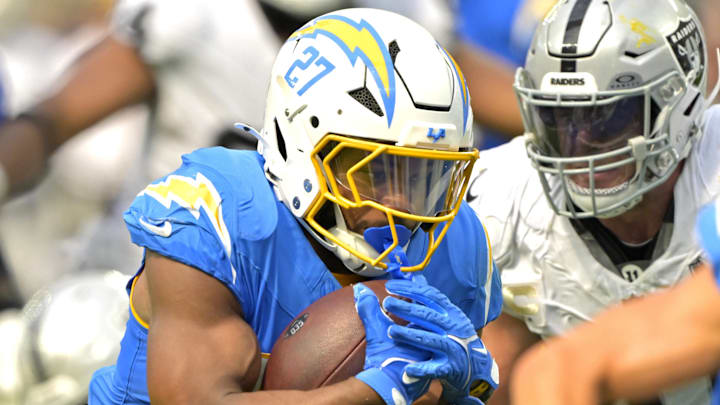 Sep 8, 2024; Inglewood, California, USA; Los Angeles Chargers running back J.K. Dobbins (27) breaks away from Las Vegas Raiders linebacker Divine Deablo (5) and runs for a touchdown in the second half at SoFi Stadium. Mandatory Credit: Jayne Kamin-Oncea-Imagn Images