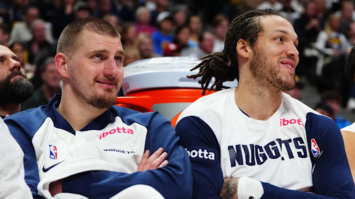 Dec 23, 2024; Denver, Colorado, USA; Denver Nuggets center Nikola Jokic (15) and forward Aaron Gordon (32) and forward Michael Porter Jr. (1) on the bench in the fourth quarter against the Phoenix Suns at Ball Arena. Mandatory Credit: Ron Chenoy-Imagn Images