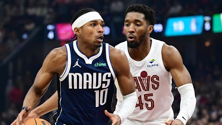 Feb 2, 2025; Cleveland, Ohio, USA; Dallas Mavericks guard Brandon Williams (10) drives to the basket against Cleveland Cavaliers guard Donovan Mitchell (45) during the first half at Rocket Mortgage FieldHouse. Mandatory Credit: Ken Blaze-Imagn Images