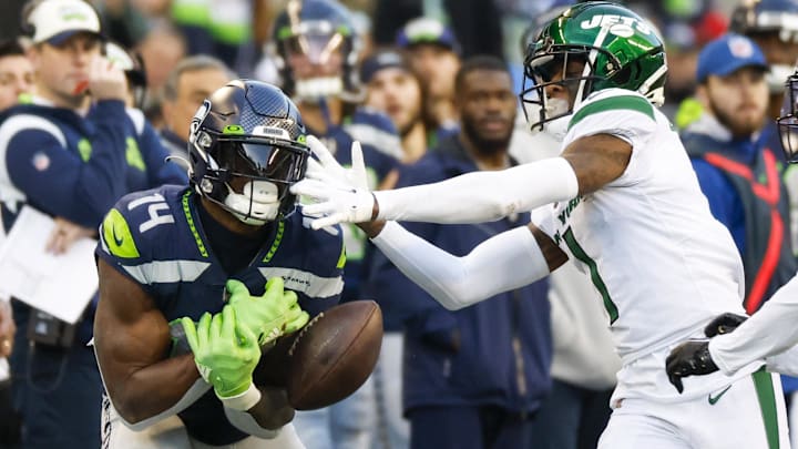 Jan 1, 2023; Seattle, Washington, USA; Seattle Seahawks wide receiver DK Metcalf (14) drops a pass while under coverage from New York Jets cornerback Sauce Gardner (1) during the fourth quarter at Lumen Field.
