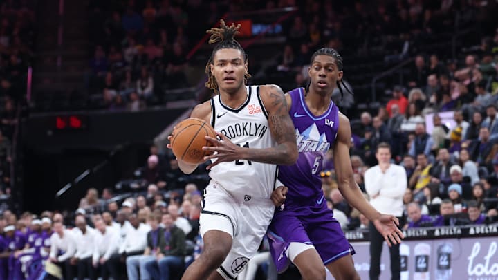 Jan 12, 2025; Salt Lake City, Utah, USA; Brooklyn Nets forward Noah Clowney (21) goes to the basket against Utah Jazz forward Cody Williams (5) during the first quarter at Delta Center. Mandatory Credit: Rob Gray-Imagn Images