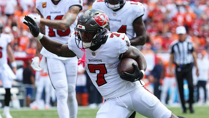 Sep 22, 2024; Tampa, Florida, USA; Tampa Bay Buccaneers running back Bucky Irving (7) runs with the ball against the Denver Broncos during the first half at Raymond James Stadium. Mandatory Credit: Kim Klement Neitzel-Imagn Images