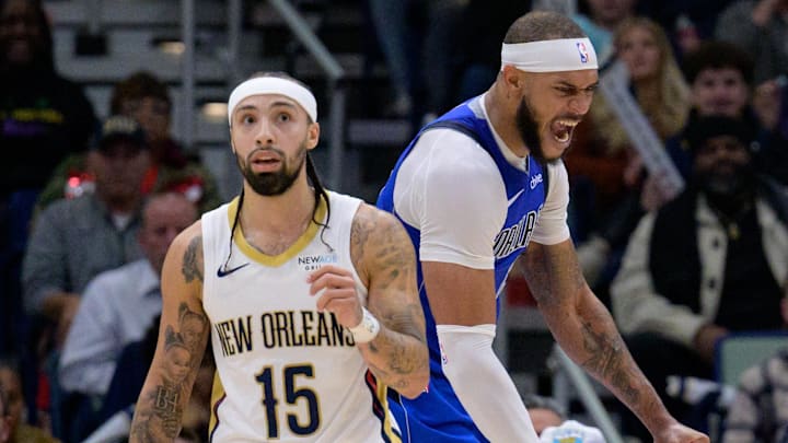 Jan 15, 2025; New Orleans, Louisiana, USA; Dallas Mavericks center Daniel Gafford (21) celebrates a dunk next to New Orleans Pelicans guard Jose Alvarado (15) during the second half at Smoothie King Center. Mandatory Credit: Matthew Hinton-Imagn Images