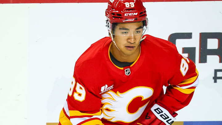 Sep 23, 2025; Calgary, Alberta, CAN; Calgary Flames defenseman Zayne Parekh (89) skates with the puck during the warmup period against the Seattle Kraken at Scotiabank Saddledome. Mandatory Credit: Sergei Belski-Imagn Images