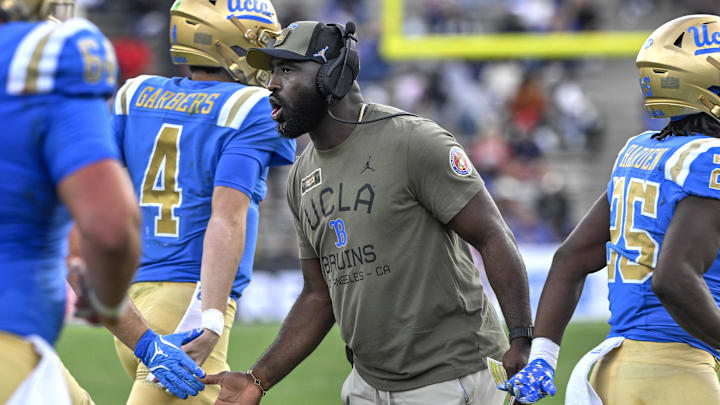 Nov 30, 2024; Pasadena, California, USA; UCLA Bruins head coach DeShaun Foster greets his players after a Bruins touchdown against the Fresno State Bulldogs in the third quarter at Rose Bowl. Mandatory Credit: Robert Hanashiro-Imagn Images