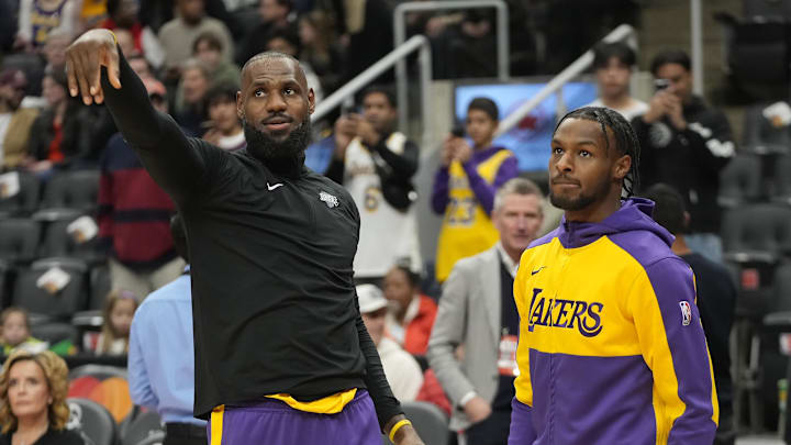 Los Angeles Lakers forward LeBron James warms up with his son Bronny James before a game. Los Angeles Lakers forward LeBron James warms up with his son Bronny James before a game.