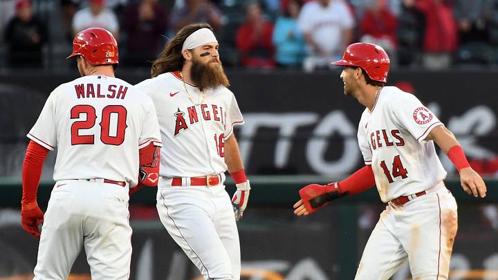 Angels third baseman Tyler Wade (14) celebrates with first baseman Jared Walsh (20) and left fielder Brandon Marsh (16) his run scored for the victory against the Miami Marlins at Angel Stadium on April 12, 2022. Angels third baseman Tyler Wade (14) celebrates with first baseman Jared Walsh (20) and left fielder Brandon Marsh (16) his run scored for the victory against the Miami Marlins at Angel Stadium on April 12, 2022.