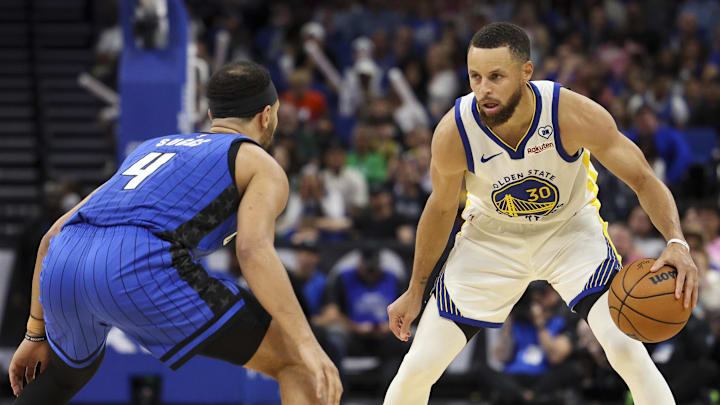 Mar 27, 2024; Orlando, Florida, USA;  Orlando Magic guard Jalen Suggs (4) guards Golden State Warriors guard Stephen Curry (30) in the fourth quarter at the Kia Center. Mandatory Credit: Nathan Ray Seebeck-Imagn Images