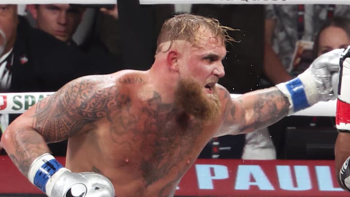 Mike Tyson (black gloves) fights Jake Paul (silver gloves) at AT&T Stadium. 