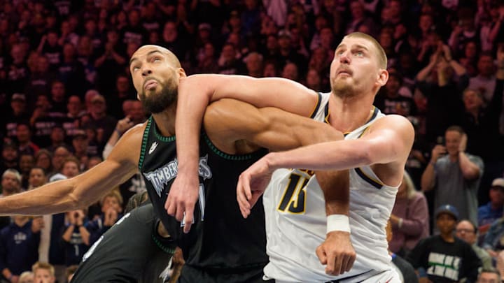 Apr 25, 2026; Minneapolis, Minnesota, USA; Minnesota Timberwolves center Rudy Gobert (27) and Denver Nuggets center Nikola Jokic (15) position themselves for a rebound in the fourth quarter at Target Center.