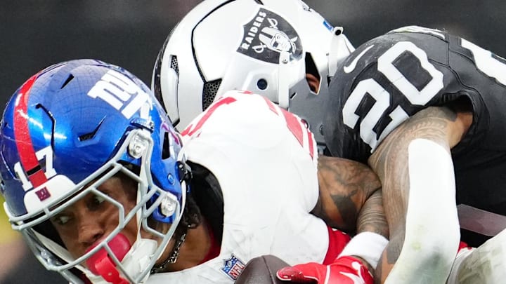 Dec 28, 2025; Paradise, Nevada, USA; New York Giants wide receiver Wan'Dale Robinson (17) is tackled by Las Vegas Raiders safety Isaiah Pola-Mao (20) in the first half at Allegiant Stadium. Mandatory Credit: Stephen R. Sylvanie-Imagn Images