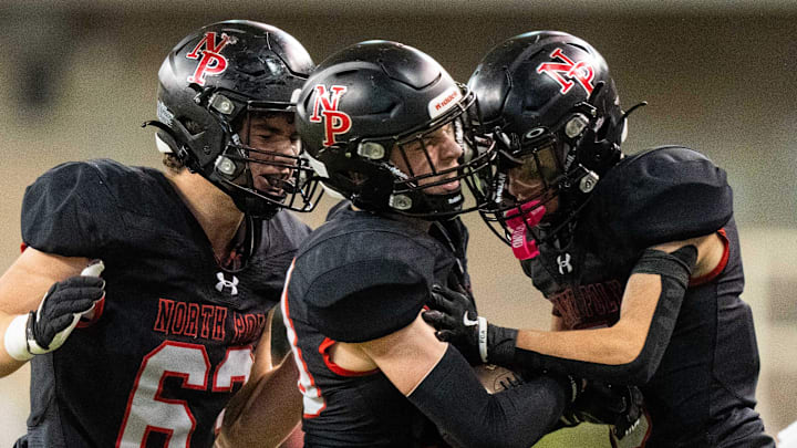 North Polk players celebrate after an interception against Pella on Thursday, Nov. 21, 2024, at the UNI-Dome in Cedar Falls, IA. North Polk players celebrate after an interception against Pella on Thursday, Nov. 21, 2024, at the UNI-Dome in Cedar Falls, IA.