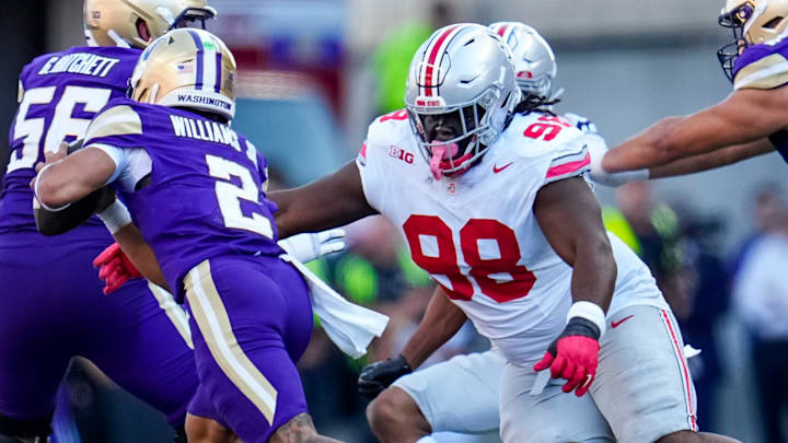 Ohio State Buckeyes defensive lineman Kayden McDonald (98) sacks Washington Huskies quarterback Demond Williams Jr. (2) during the second half of the NCAA football game at Husky Stadium in Seattle on Sept. 27, 2025. Ohio State won 24-6.
