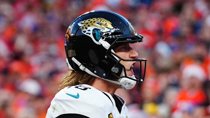 Dec 21, 2025; Denver, Colorado, USA; Jacksonville Jaguars quarterback Trevor Lawrence (16) reacts after rushing for a touchdown against the Denver Broncos during the second half at Empower Field at Mile High. Mandatory Credit: Ron Chenoy-Imagn Images