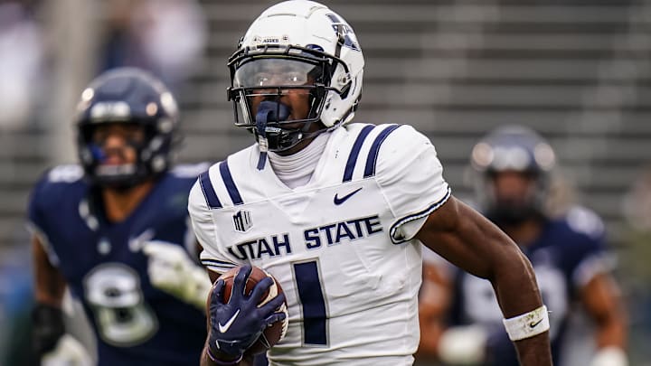 Sep 30, 2023; East Hartford, Connecticut, USA; Utah State Aggies wide receiver Jalen Royals (1) runs the ball for a touchdown against the UConn Huskies in the second half at Rentschler Field at Pratt & Whitney Stadium. Mandatory Credit: David Butler II-Imagn Images