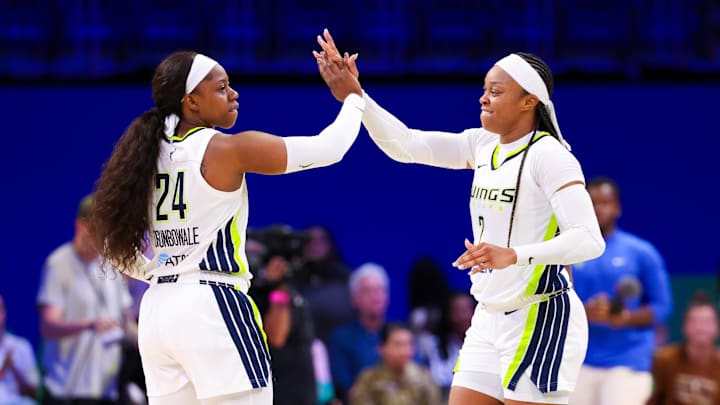 Dallas Wings guard Arike Ogunbowale celebrates with guard Odyssey Sims after the game.