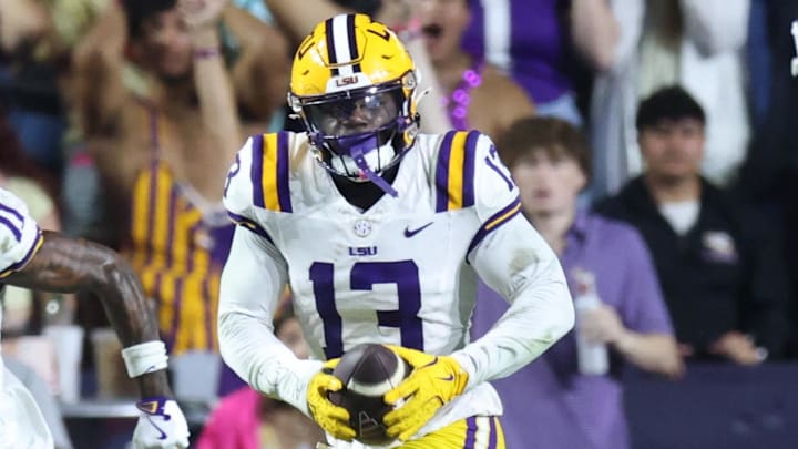 Oct 25, 2025; Baton Rouge, Louisiana, USA; Louisiana State Tigers defensive back A.J. Haulcy (13) returns an interception against Texas A&M Aggies quarterback Marcel Reed (10) during the first half at Tiger Stadium. Mandatory Credit: Stephen Lew-Imagn Images Oct 25, 2025; Baton Rouge, Louisiana, USA; Louisiana State Tigers defensive back A.J. Haulcy (13) returns an interception against Texas A&M Aggies quarterback Marcel Reed (10) during the first half at Tiger Stadium. Mandatory Credit: Stephen Lew-Imagn Images