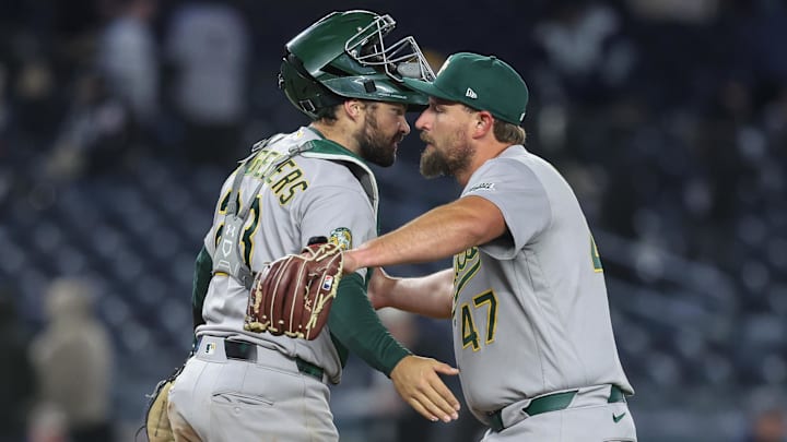 Apr 8, 2026; Bronx, New York, USA;  Athletics relief pitcher Joel Kuhnel (47) and catcher Shea Langeliers (23) celebrate after defeating the New York Yankees 3-2 at Yankee Stadium. Mandatory Credit: Wendell Cruz-Imagn Images