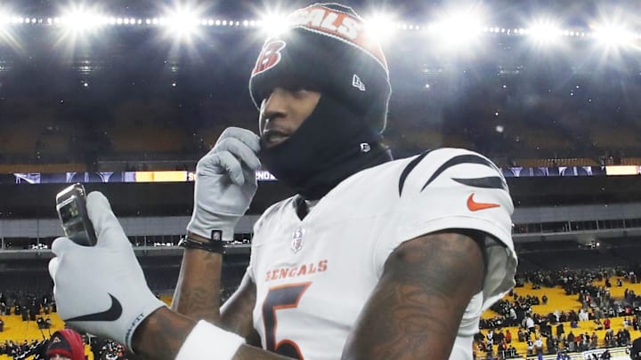 Jan 4, 2025; Pittsburgh, Pennsylvania, USA;  Cincinnati Bengals wide receiver Tee Higgins (5) goes live on social media after defeating the Pittsburgh Steelers at Acrisure Stadium. Mandatory Credit: Charles LeClaire-Imagn Images