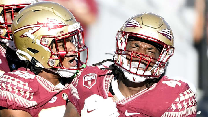 Oct 1, 2022; Tallahassee, Florida, USA; Florida State Seminoles defensive end Patrick Payton (56) celebrates a sack with defensive tackle Joshua Farmer (44) during the second half against the Wake Forest Demon Deacons at Doak S. Campbell Stadium. Mandatory Credit: Melina Myers-Imagn Images