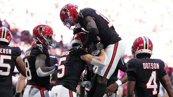 Atlanta Falcons wide receiver Drake London celebrates with wide receiver Chris Blair after catching a 21-yard touchdown pass.
