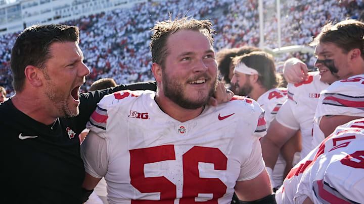 Ohio State Buckeyes offensive line coach Justin Frye celebrates with offensive lineman Seth McLaughlin.