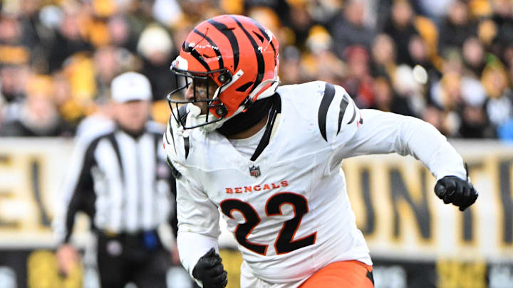 Nov 16, 2025; Pittsburgh, Pennsylvania, USA; Pittsburgh Steelers running back Kenneth Gainwell (14) leaps in the air while running with the ball against Cincinnati Bengals safety Geno Stone (22) during the second half at Acrisure Stadium. Mandatory Credit: Barry Reeger-Imagn Images