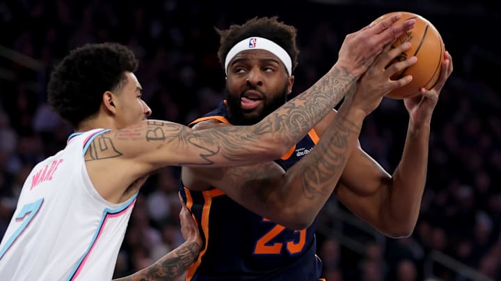 Mar 17, 2025; New York, New York, USA; New York Knicks center Mitchell Robinson (23) drives to the basket against Miami Heat center Kel'el Ware (7) during the first quarter at Madison Square Garden. Mandatory Credit: Brad Penner-Imagn Images
