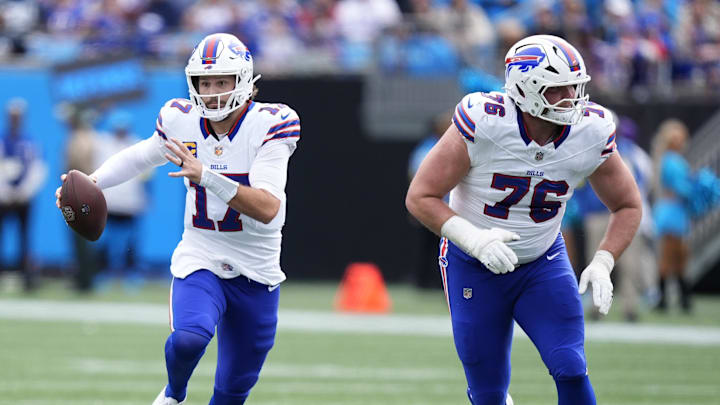 Oct 26, 2025; Charlotte, North Carolina, USA; Buffalo Bills quarterback Josh Allen (17) scrambles behind guard David Edwards (76) during the first half against the Carolina Panthers at Bank of America Stadium. Mandatory Credit: Jim Dedmon-Imagn Images