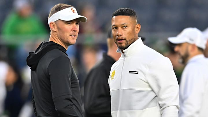 Oct 14, 2023; South Bend, Indiana, USA; USC Trojans head coach Lincoln Riley and Notre Dame Fighting Irish head coach Marcus Freeman chat before the game at Notre Dame Stadium. Mandatory Credit: Matt Cashore-Imagn Images Oct 14, 2023; South Bend, Indiana, USA; USC Trojans head coach Lincoln Riley and Notre Dame Fighting Irish head coach Marcus Freeman chat before the game at Notre Dame Stadium. Mandatory Credit: Matt Cashore-Imagn Images
